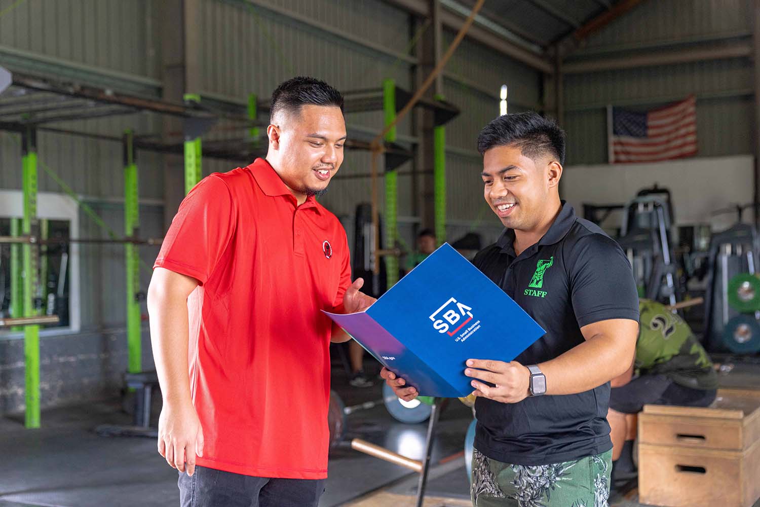 CNMI SBDC Marketing Manager and Outreach Specialist Roman Tudela speaks with Latte Built staff member Ralph Villas. 