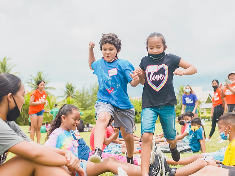 Campers from House of Taga challenge each other during a game of  “Human Ladder”.