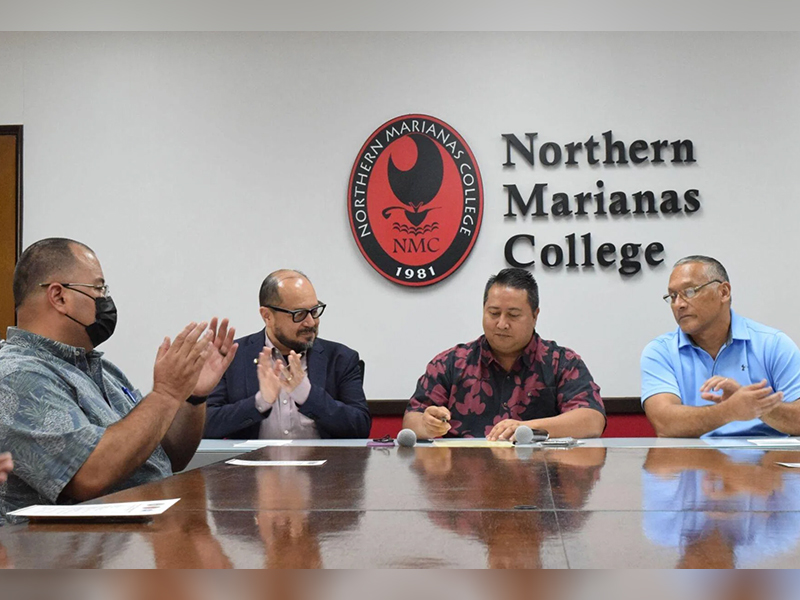 Northern Marianas College President Dr. Galvin Deleon Guerrero, second left, Speaker Edmund S. Villagomez, left, and NMC Board of Regent Chairman Charles Cepeda, right, applaud after Gov. Ralph DLG Torres signed the proclamation declaring April as Community College Month in the NMC board conference room on Monday. Photo by Emmanuel T. Erediano