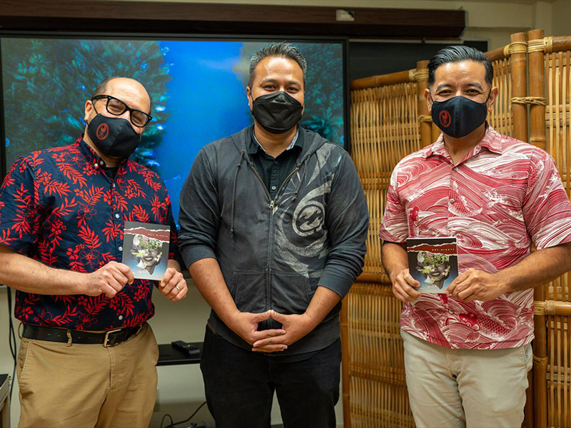 Northern Marianas College President Galvin Deleon Guerrero, left, and Vice President Frankie Eliptico, right, hold copies of the film "Dry Nights" with the film's director, Brian Muna, during a visit on Feb. 1 to UOG Press at the University of Guam. The film was co-directed by UOG Press Managing Editor Victoria-Lola Leon Guerrero and based on the UOG Press book "Dry Nights" by Guam author Pep Borja. Northern Marianas College now has its own imprint under UOG Press to begin publishing works specific to the Northern Mariana Islands and written by NMI authors. UOG photo