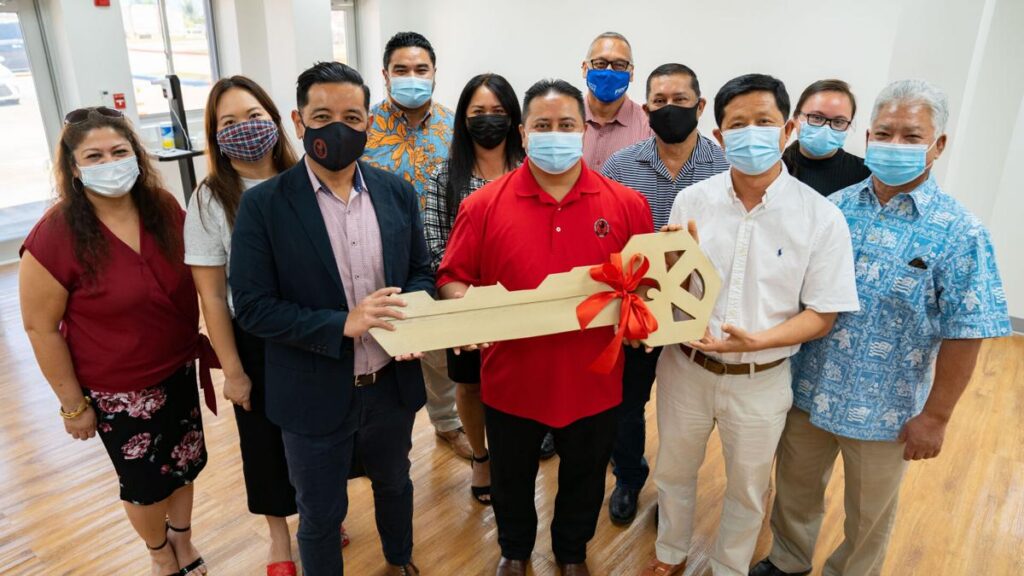 NMC Interim President Frankie Eliptico, third left, and Gov. Ralph DLG Torres, center, pose with NMC regents as they receive the ceremonial “key” from contractor principal Steve Qian of USA Fanter.