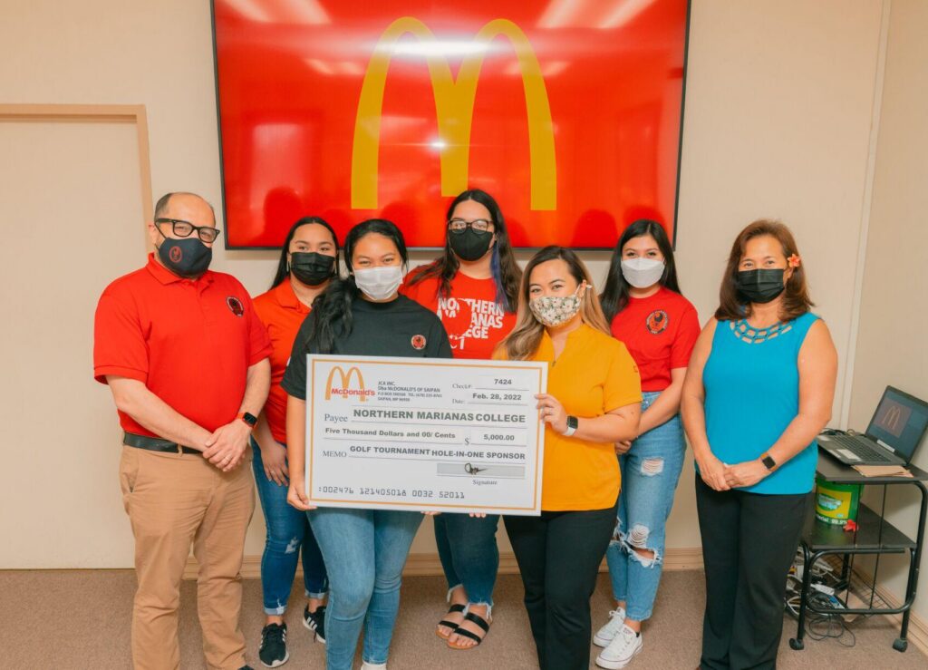 Northern Marianas College President Galvin Deleon Guerrero, EdD, left, poses with McDonald’s of Saipan and Guam vice president and owner/operator Marcia Ayuyu, right, executive assistant to the president Mable A. Glenn, and other NMC representatives at the McDonald's main office on Monday during the presentation of a check for $5,000 — McDonald’s hole-in-one prize donation to the NMC Golf Open. Photo by James F. Sablan Jr.